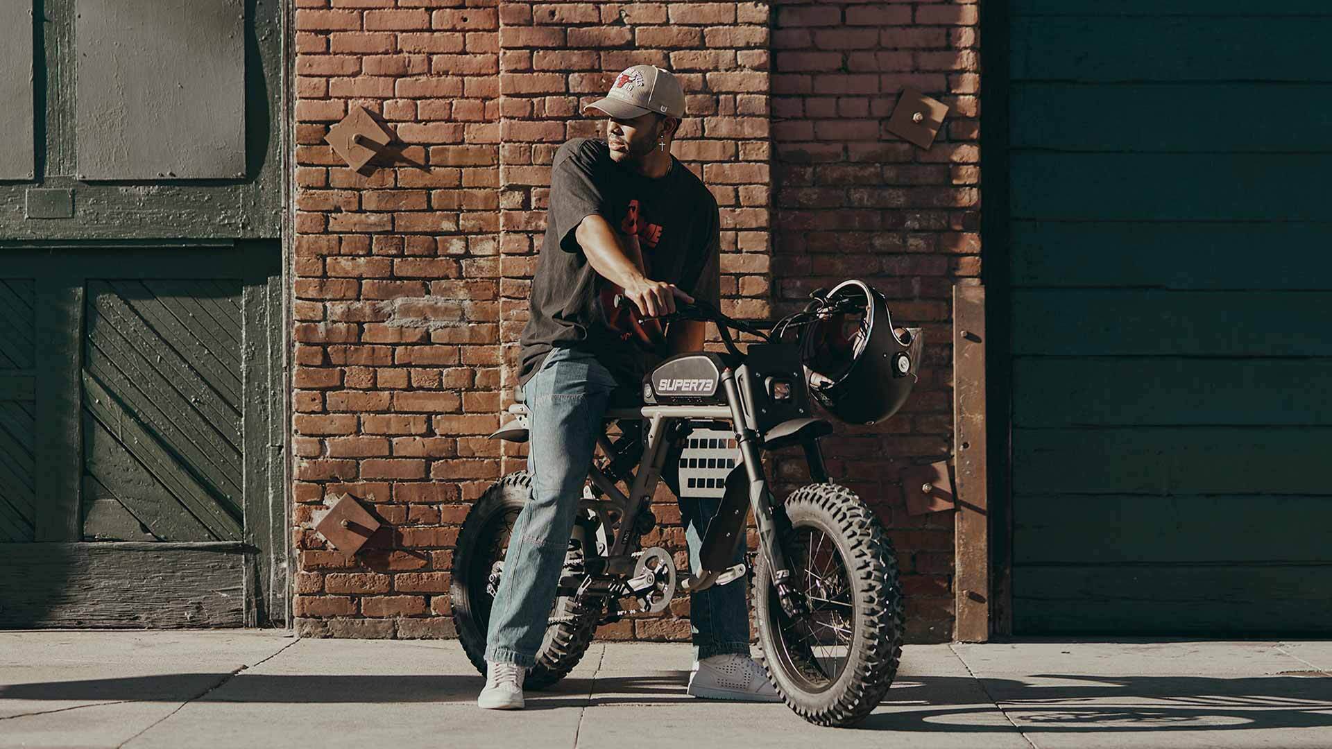 Rider on a Super73 ebike on an urban street looking into the distance