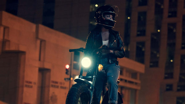 Woman riding a Super73 ebike in the night