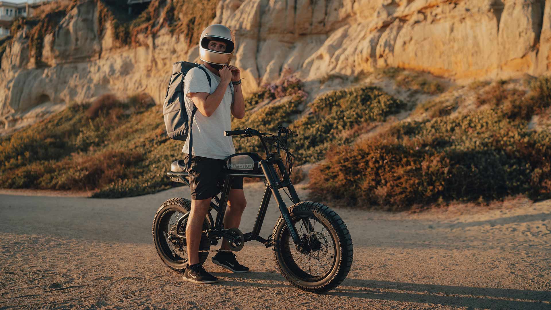 Man riding SUPER73-R on the sand.
