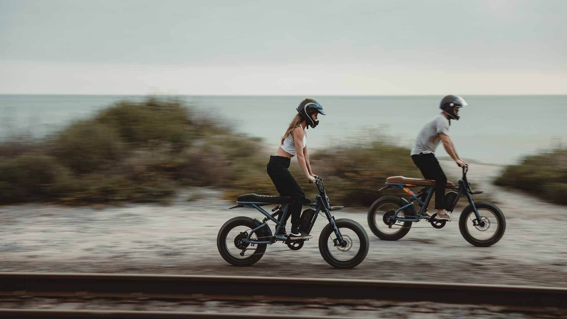 A woman and a man riding Super73 Adventure Series bikes 