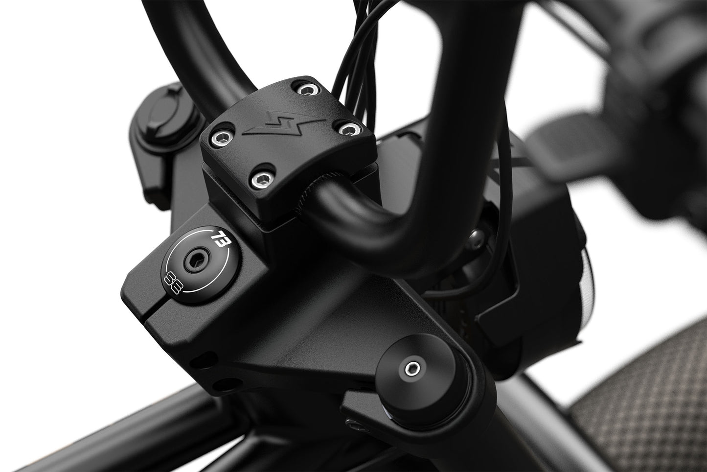 Close-up of a super 73 motorcycle handlebar with control buttons on a blurred background