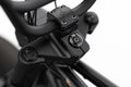 Close-up of a black motorcycle handlebar with visible branding on a white background