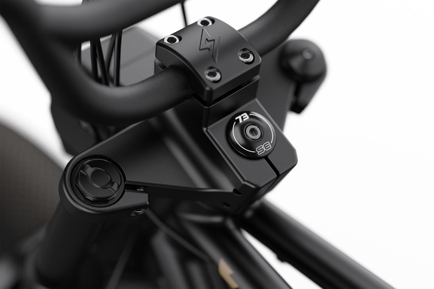 Close-up of a black motorcycle handlebar with visible branding on a white background