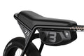 Close-up of a black bicycle seat and frame with '73' branding on a white background
