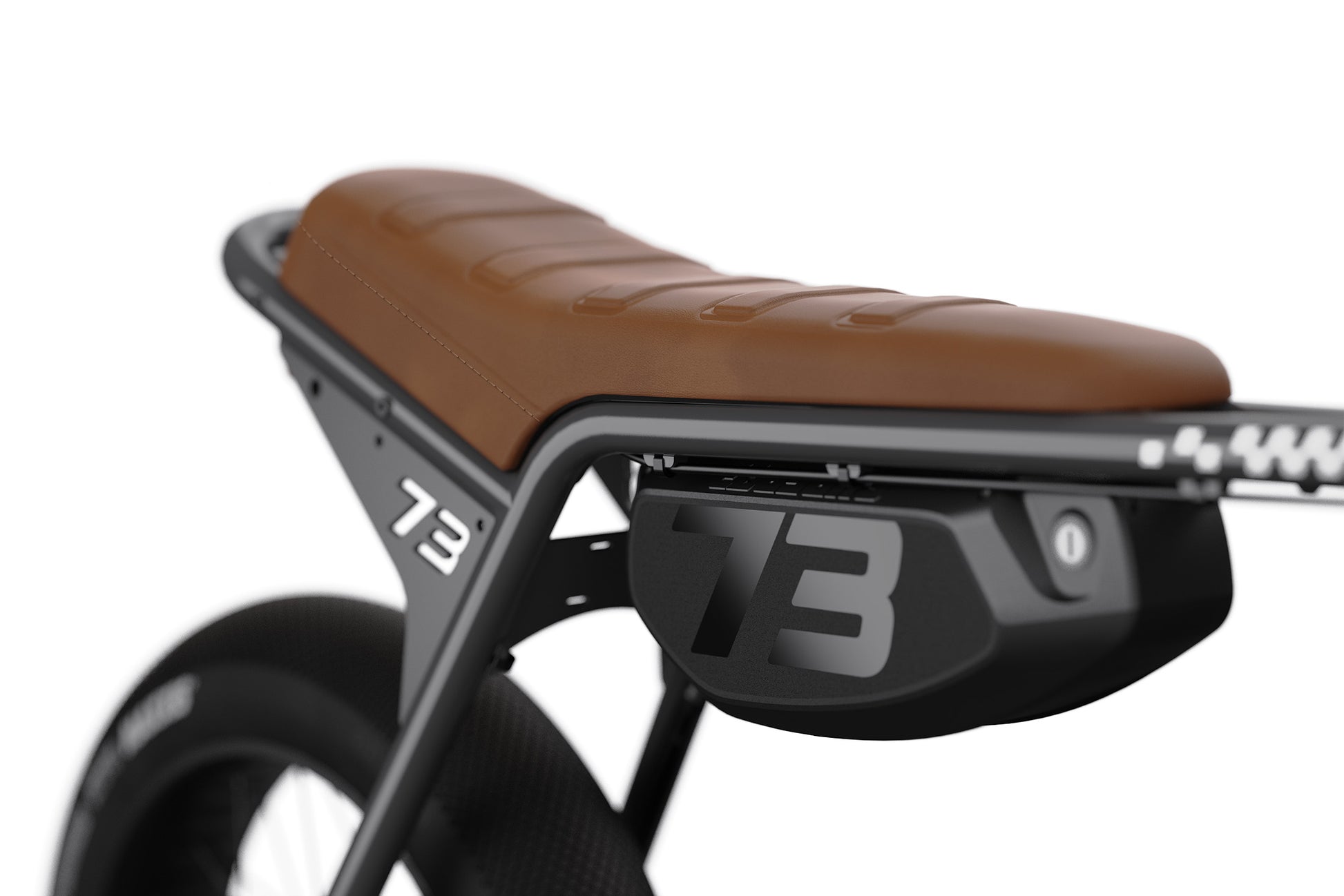 Brown motorcycle seat with black metal frame and '73' branding on a white background