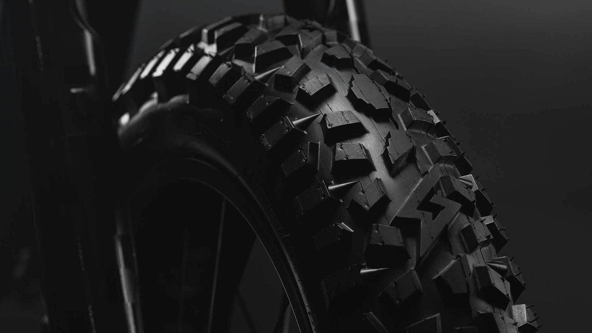 Detail shot of the GRZLY tires on the SUPER73-R Blackout SE bike.