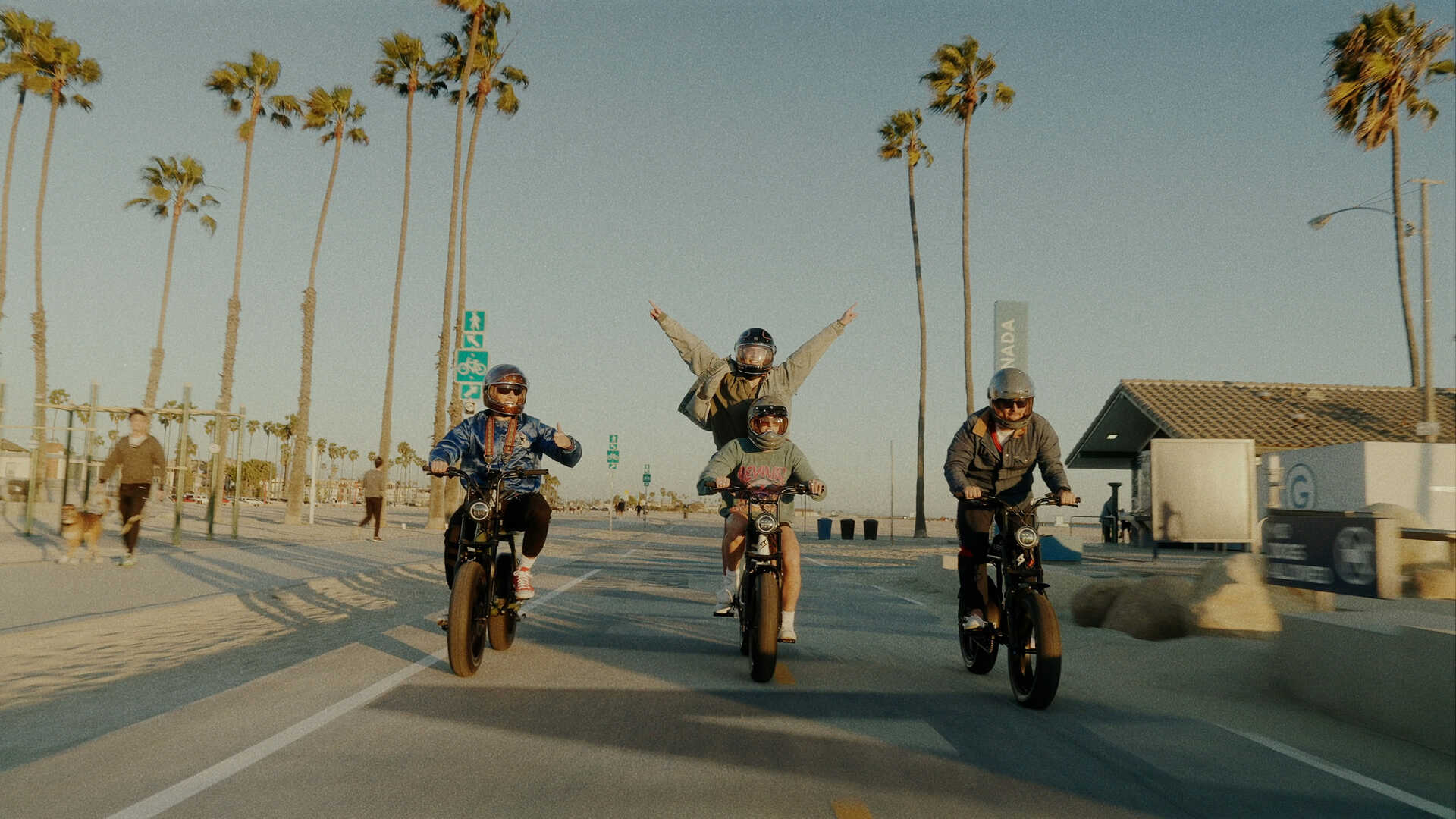 A group of friends riding their Super73 ebikes on the shore