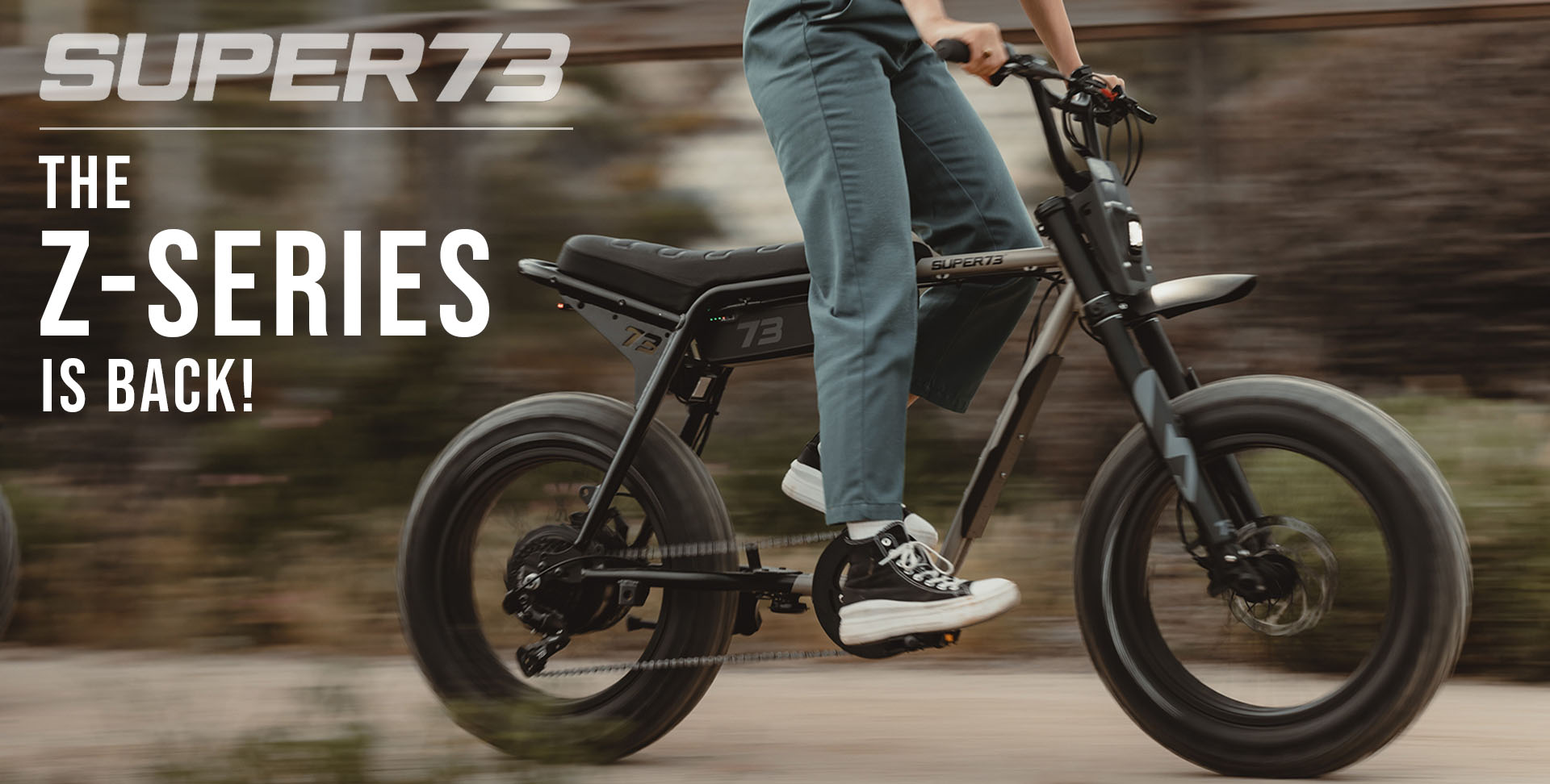 Person riding a Super73 electric bike with promotional text overlay.