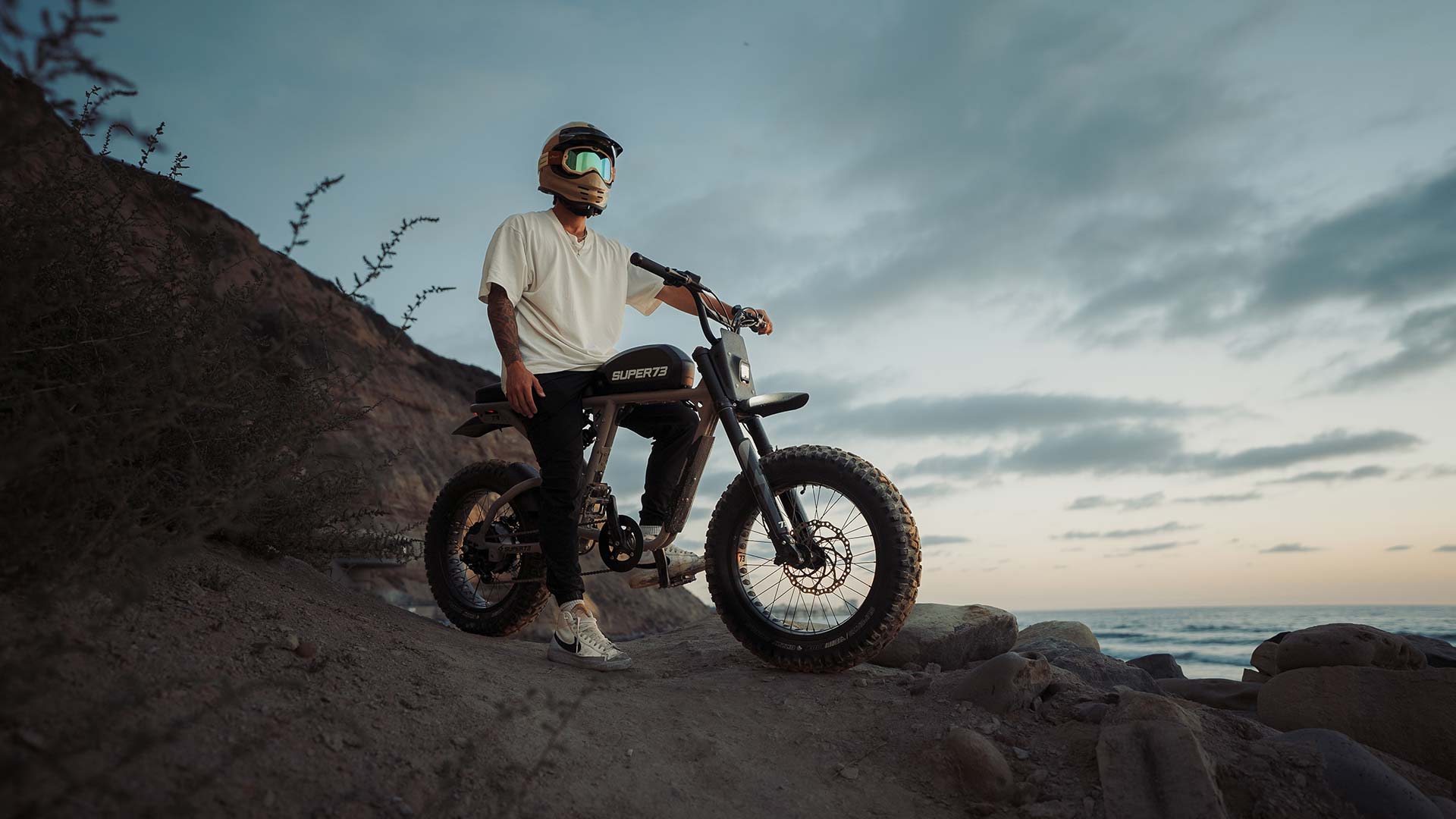 Man standing on the top of the hill with his Super73-RX Dark Earth