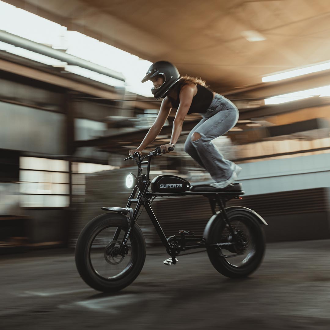 Woman making stunts on a Super73-S2 Obsidian