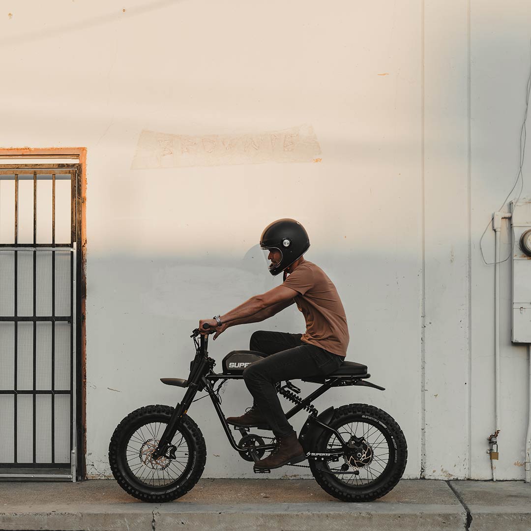 Super73 RX Mojave ebike rider cruising on sidewalk. Full side profile