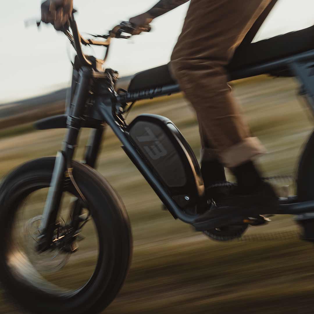 Lifestyle image of a rider riding the S Adventure on a grassy field and wearing a helmet.