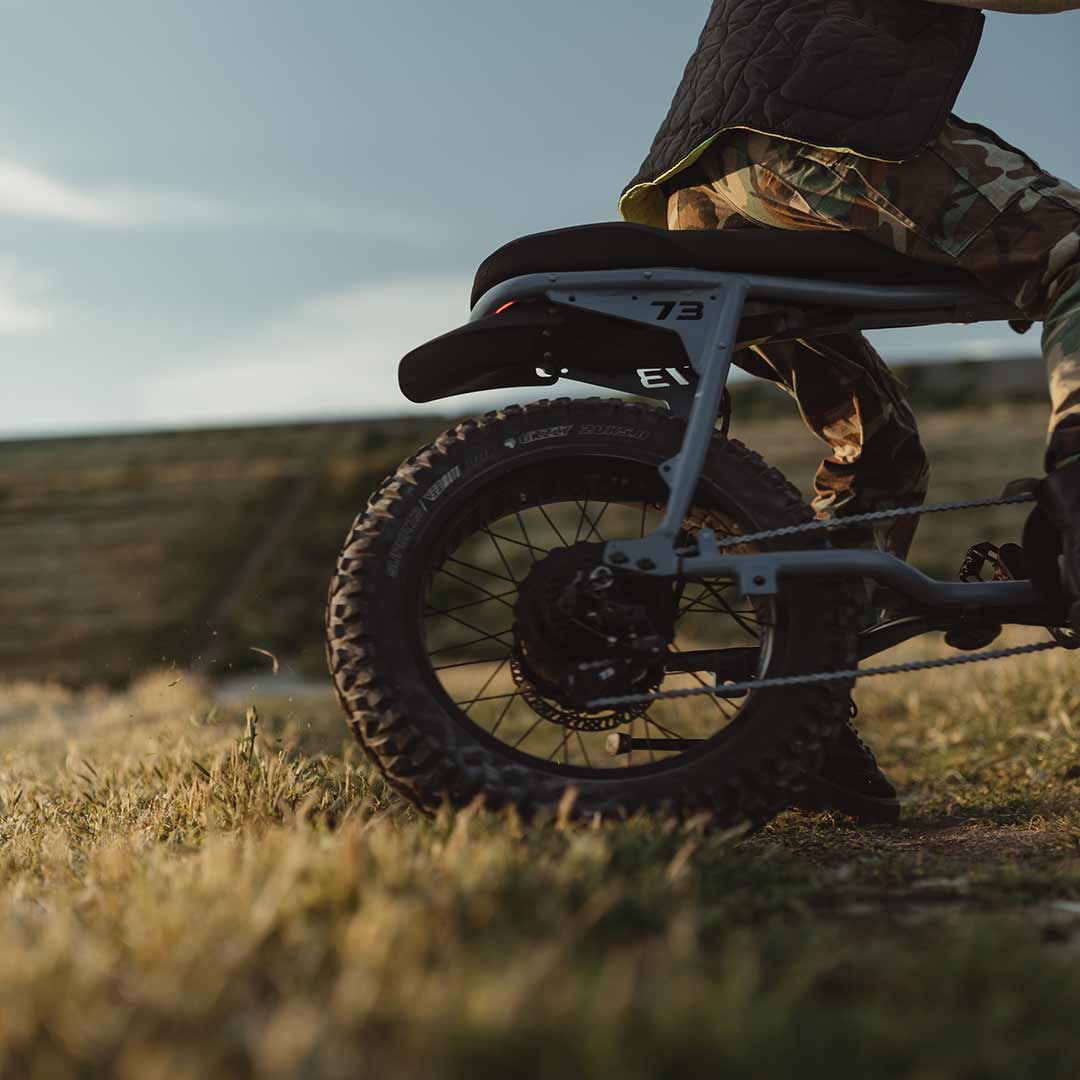 Lifestyle image of a rider riding the S Adventure down a cement slope wearing a helmet.