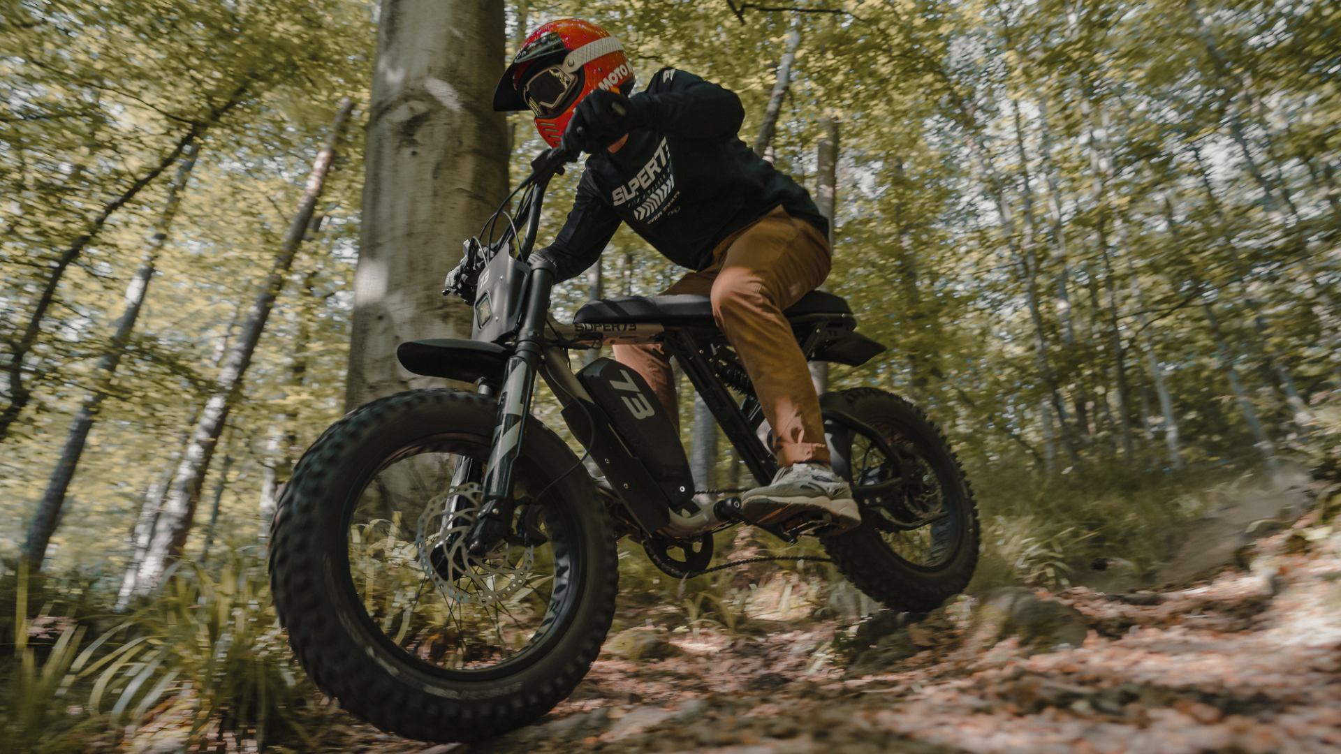 Man is riding a Super73-R Adventure ebike in the forest of Belgium